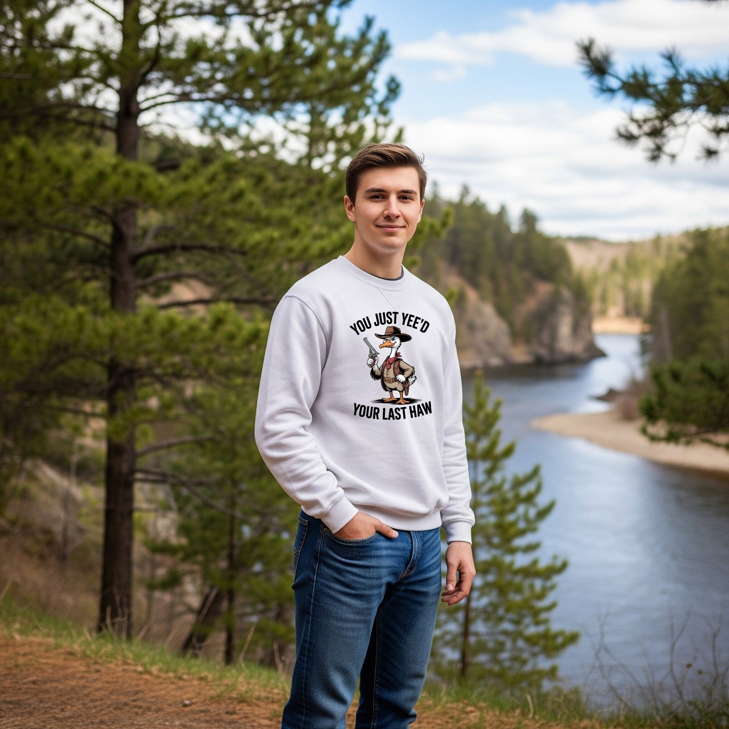 Person wearing a sweatshirt with a graphic design in a natural setting